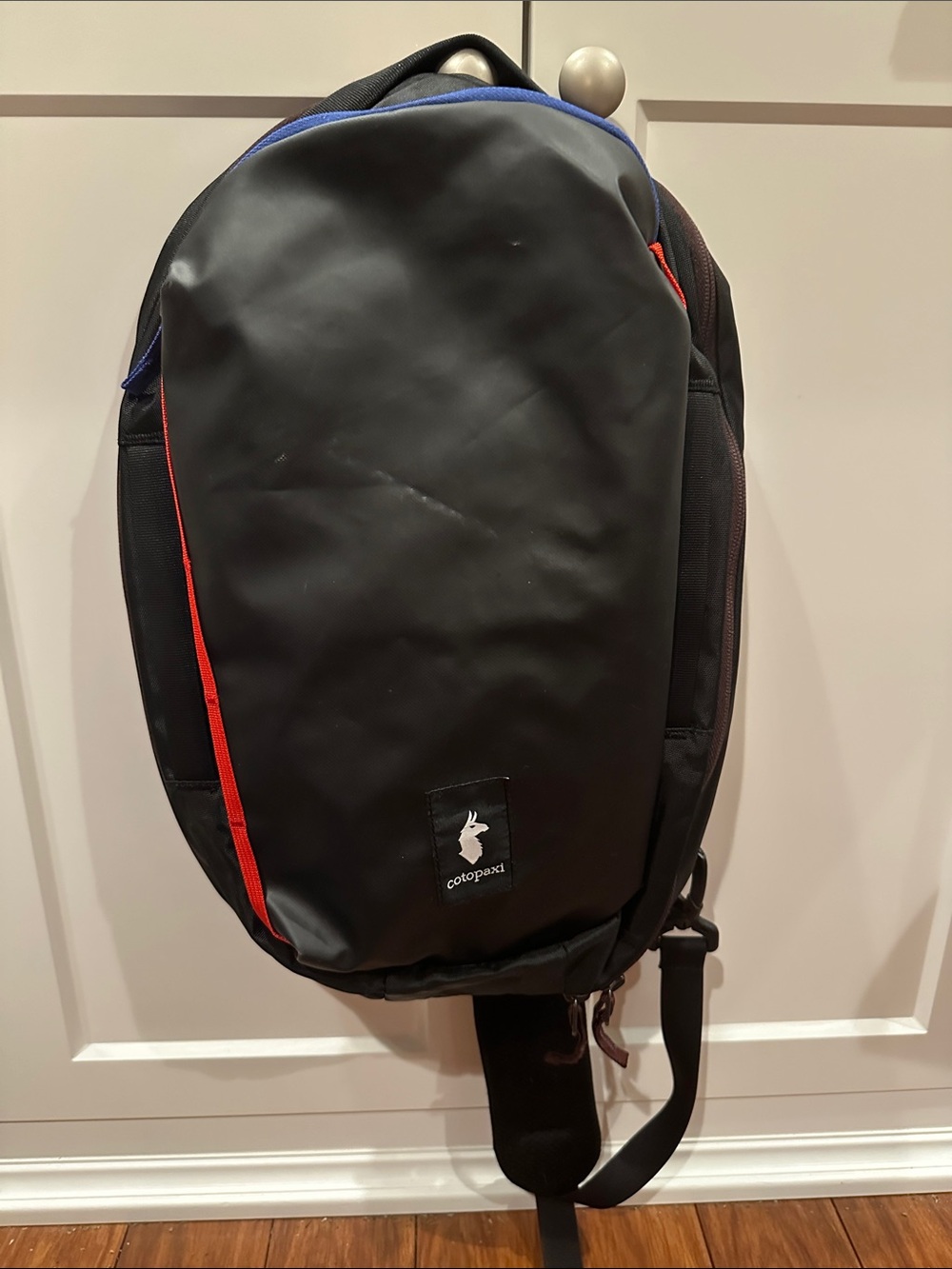 Cotopaxi Chasqui 13L Black Sling Bag with Red, Brown and Blue Accents